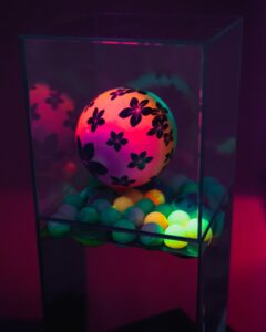 Karambol - collective work, water installation, glass, mirror, balls and UV neon